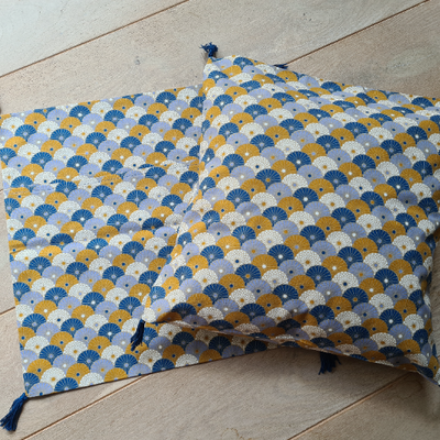 Housse de coussin avec pompons ocre et bleu